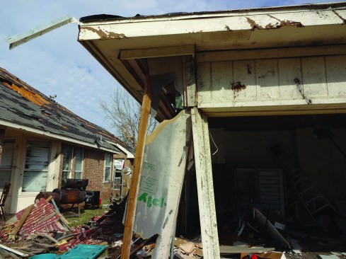 Another example shows the same pattern, as well as the failure of a garage door. In both cases, properly designed and installed portal frames would have likely improved the performance of the homes.