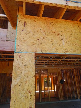 Breaking the structural panel joint below the header reduces the elbow’s resistance to rotation.