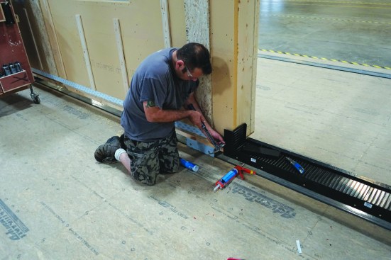 Ray Zabel installs the standard sill pan detail of a doorway rough opening prior to the door install.