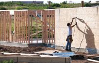 Code requires nailing along all edges of braced wall panels. This may require blocking between studs on tall walls or when panels are run horizontally. (photo: Chris Ulster)