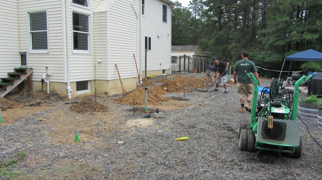 Instead of massive concrete footings, helical piers—each capable of supporting 5,000 to 8,000 pounds—were installed to support the freestanding deck.