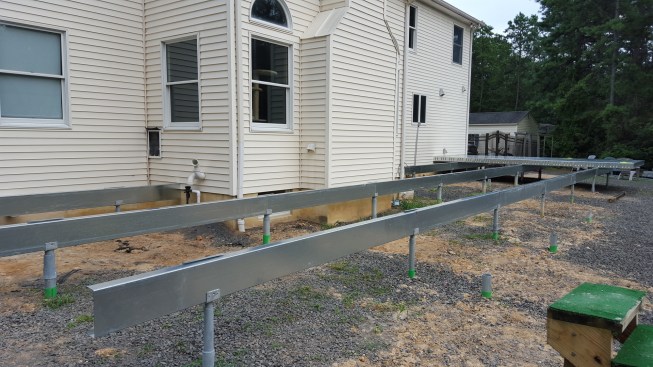 The 6 1/4-inch Paverdeck panels are screwed to galvanized 10-inch LGS steel beams bolted to the brackets on top of the piers