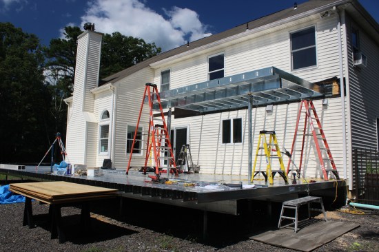 The LGS joists on the upper deck hang from galvanized rim track with preformed, prepunched tabs at standard spacings.