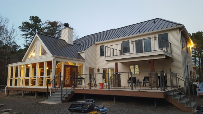 For low maintenance, the porch trim and the balcony trim were wrapped with PVC-coated coil stock, while Trex fascia trim was used to finish the edge of the deck and the stair stringers.