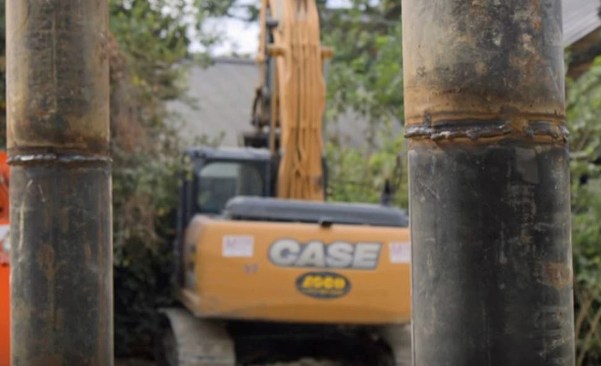 Once that first length was just a few feet out of the ground, we brought over a new section with the forklift and welded it on.