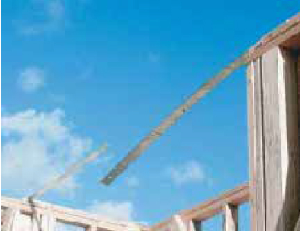 In this framing sequence, straps attached to the tops of shear walls are left hanging.