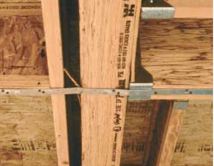 The missing block in this collector between the girder and the I-joist to its left could prove costly in an earthquake: The back-and-forth cycling of the quake will smash the two members together, folding and stretching the strap below until it fails.