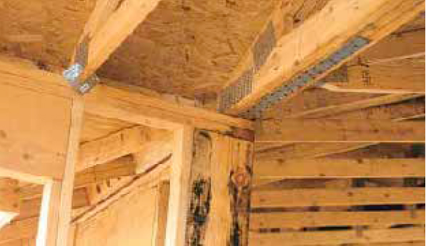 In this photo, straps running in both directions connect the wood I-joist second-floor framing to the shear walls below.