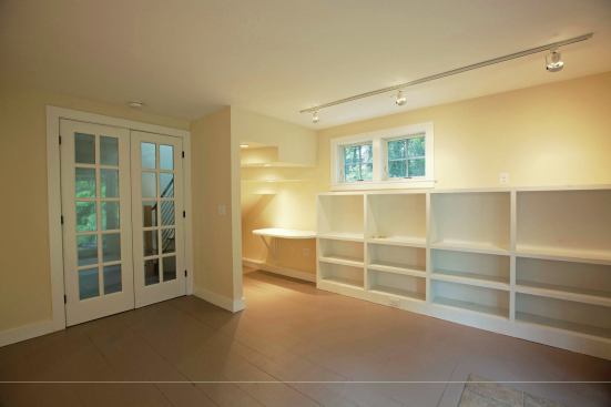 In the area under the stairs, we added lighting and a built-in desktop to create a small “found space” office.