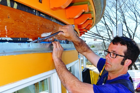 Pollard pried off the existing zinc flashing.