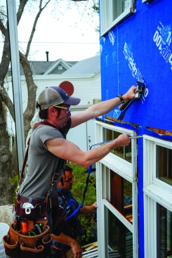 When the entire ocean-facing wall had been weather-protected, the crew could start tearing out the existing Andersen windows and replacing them with new Marvin windows, one or two openings at a time. After slitting along the edge of each aluminum window flange, Strout pulled nails from the flanges with a cat’s paw.