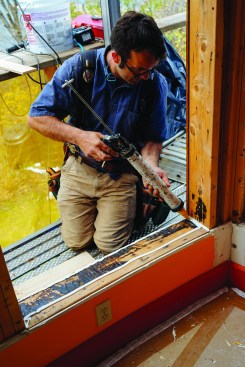 Next, Pollard prepped the window rough sills: first he applied a bead of adhesive caulk.