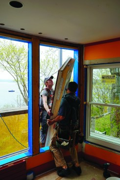 Pollard and Strout installed the new Marvin windows into the prepared openings. They muscled the new units out onto the scaffolding and tacked them in place.