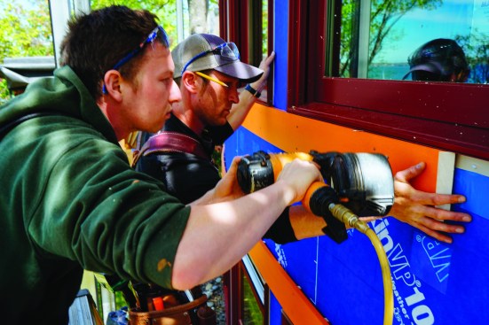 Then the carpenters nailed the trim pieces above and below the windows. Hand pressurewas enough to fit the pine trim to the wall radius.