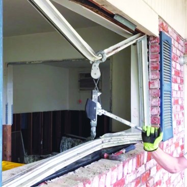 The author identified several existing homes that were gutted and standing empty. The crew pulled existing single-glazed windows from the openings.