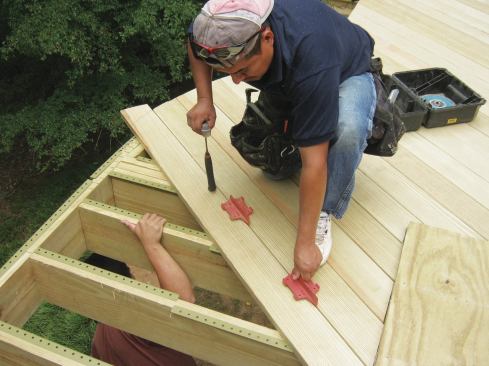 When wood decking is installed, the gaps between the deck boards should be sized according to their moisture content at the time of installation. Kiln-dried decking will require wider gaps than wet lumber.
