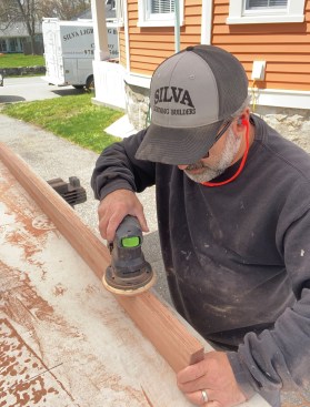 Prior to finishing, he sanded the rails with 100-grit paper.