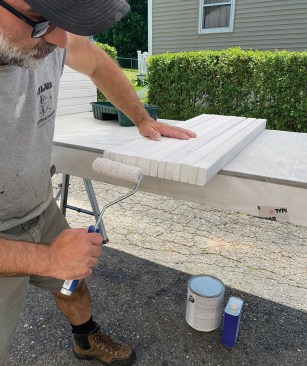 Coating end grain with primer and paint prior to assembly helps prevent the wood balusters from wicking up moisture.