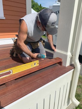 The author secures the bottom rails with screws long enough to penetrate the column framing.