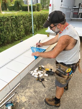 Then I flipped the table over and marked layout lines on the top skin with a Sharpie permanent marker every 6 inches on-center. On the 1-foot intervals, I extended the lines the full height of my layout square; in between, I drew the lines only 6 inches long.