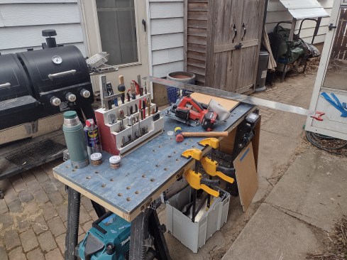 The worktops provide a flat work surface for many tasks. Note the drilled holes for clamps as well as the clips on the edges for hanging tools within easy reach.
